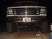 1994 Ford Bronco - Front view of a white Ford Bronco with a chrome grille and large tires, displaying a Japanese license plate.